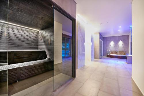 a bathroom with a walk in shower and a glass wall at Cascade Wellness Resort in Lagos