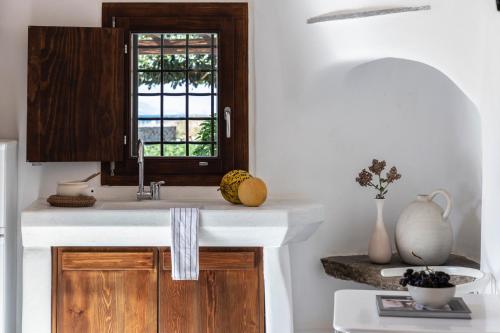 a kitchen with a sink and a window at Aqua Breeze Villas on the beach in Plaka