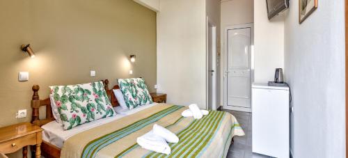 a bedroom with a bed in a room at Silver Beach Hotel in Kardamaina