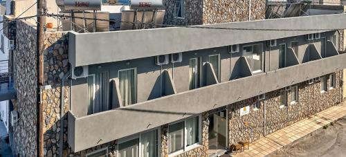 a building with many windows on the side of it at Silver Beach Hotel in Kardamaina
