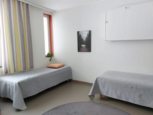 a room with two beds and a window at Hostel Teopolis in Tampere