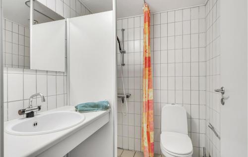 a bathroom with a sink and a toilet at Nice Apartment In Rudkbing With Wifi And 2 Bedrooms in Rudkøbing