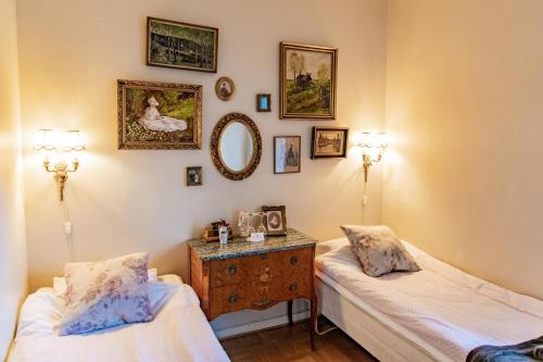 a room with two beds and a table with a mirror at Sweet Dreams B&B Ullared in Ullared