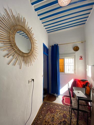a room with a mirror on the wall and a table at Ibn Batouta House in Tangier