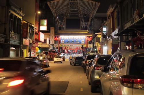 a city street filled with lots of cars at night at Rain Forest Hotel in Kuala Lumpur