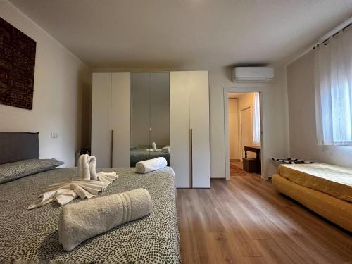 a large bedroom with two beds and a bathroom at Extravaganza Room and Suite Apartment City Center in Cagliari