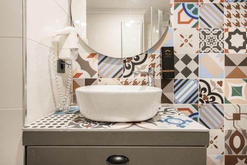 a bathroom with a sink and a mirror at Lovely Studio Flat near Hadrians Gate in Antalya