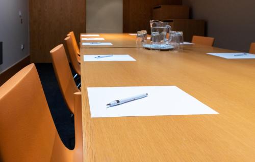 a pen sitting on top of a wooden table at The Lawrance Luxury Aparthotel - Harrogate in Harrogate