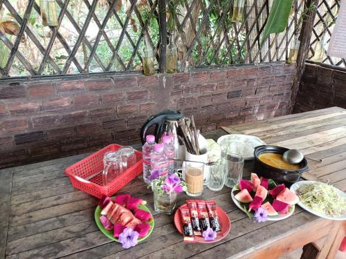 a picnic table with food and drinks on it at Phonluer Angkor Homestay, in Siem Reap