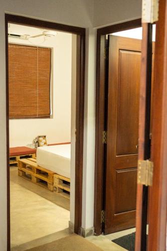 a bedroom with a bed and a sliding glass door at Battaramulla Boutique Villa in Sri Jayewardenepura Kotte