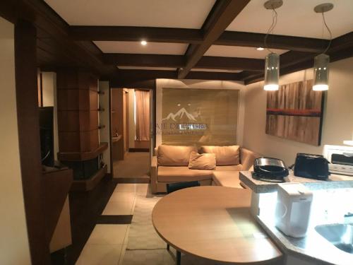 a living room with a couch and a table at Laje de Pedra Mountain VillagePrime in Canela