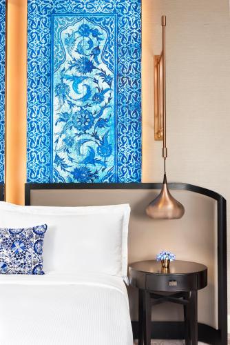 a bedroom with a bed and a blue and white wall at The Ritz-Carlton, Istanbul at the Bosphorus in Istanbul