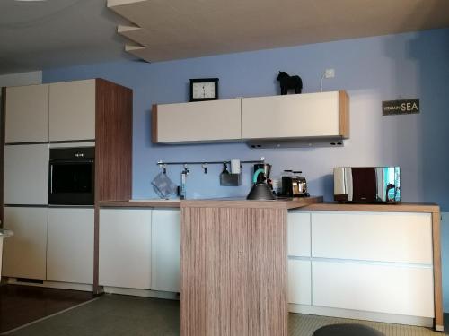 a kitchen with white cabinets and a counter at Appartement Baju in Bad Urach