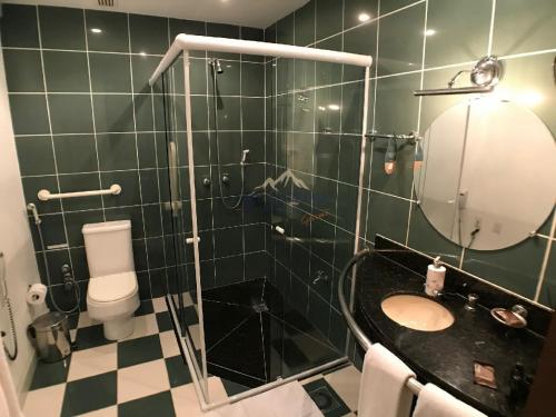 a bathroom with a sink and a toilet and a mirror at Laje de Pedra Mountain VillagePrime in Canela