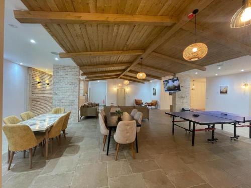 a living room with a table and chairs and a couch at Riverside in Majdal Shams