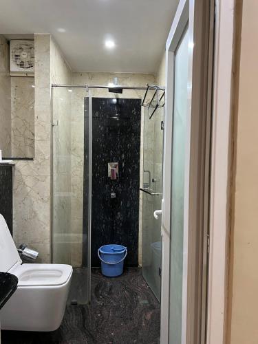 a bathroom with a shower and a sink and a toilet at Hotel Lee Garden Near to Blue Flag Beach 500 Mtrs in Puri