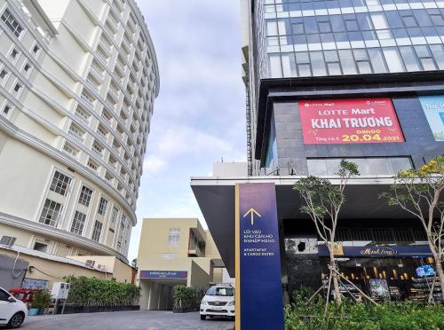 a sign in the middle of a city with buildings at Gold Coast Luxury Apartment Nha Trang in Nha Trang
