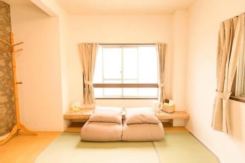 a room with a bean bag chair in front of a window at Osaka SENJU big Tatami house Max 16ppl direct to KIX airport in Osaka