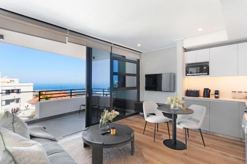 a living room with a view of the ocean at Casa on Bantry by Totalstay in Cape Town