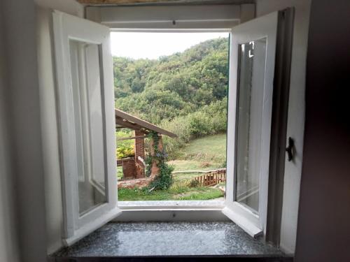 an open window with a view of a mountain at B&B Sant'Anna in Cairo Montenotte