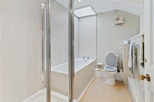 a bathroom with a shower and a toilet at Finest Retreats - Harbour House in Craster