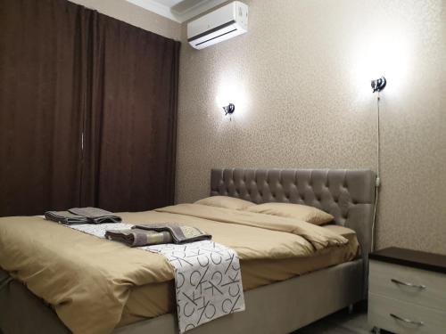a bedroom with two beds and two lights on the wall at Modern 1BD apartment with living room in the park zone in Chişinău