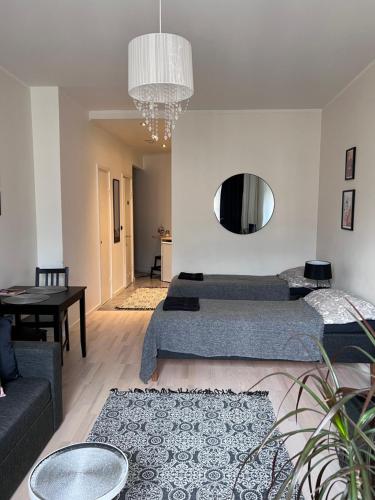 a living room with two beds and a couch at Beautiful city apartment at Kallio in Helsinki
