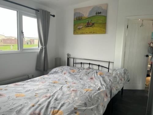 a bedroom with a bed and a window at S and S Chalets Mablethorpe in Mablethorpe