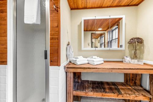 a bathroom with a wooden counter and a mirror at A-Frame of Mind in Beech Mountain