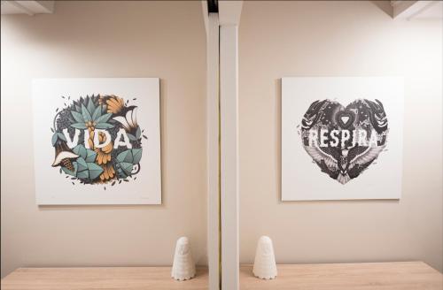 a room with two posters on the wall and a table at Happy Hostal Carrales in Burgos