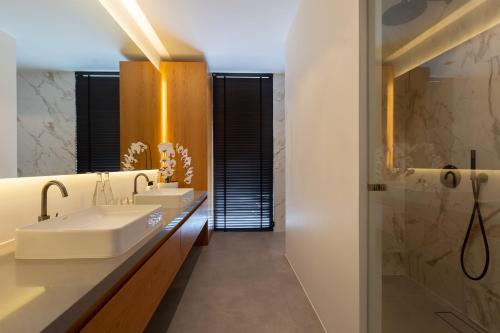 a bathroom with two sinks and a shower at Villa Amylia Emerald, design excellence in Koh Samui
