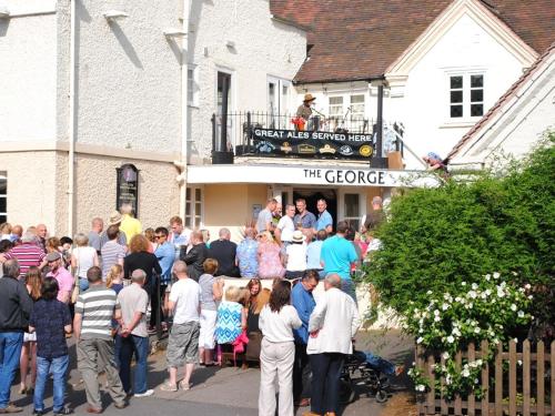 a crowd of people standing outside of a building at The George in Bridgnorth