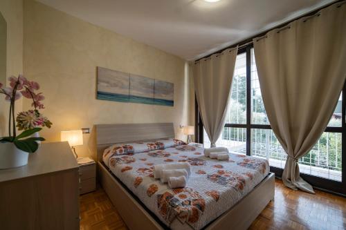 a bedroom with a bed and a large window at ISEO CHARME VILLAS in Iseo