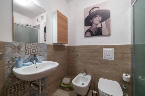 a bathroom with a sink and a toilet at ISEO CHARME VILLAS in Iseo