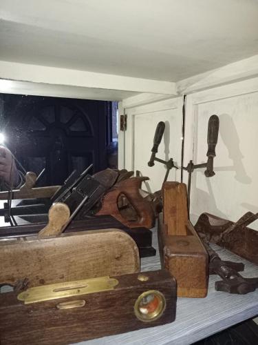 a pile of old tools sitting on a shelf at Casas do Durão-Memories House in Lajeosa