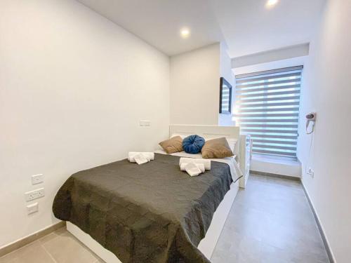a bedroom with a bed with two towels on it at Seafront 1st floor Apartment in Marsaskala by Solea in Marsaskala