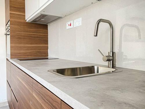 a kitchen with a stainless steel sink in it at Seafront 1st floor Apartment in Marsaskala by Solea in Marsaskala