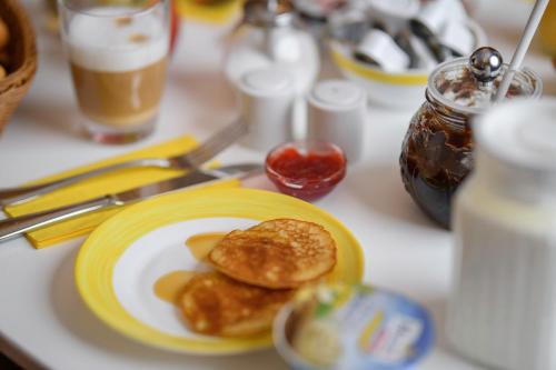 a plate of food with pancakes on a table at Hotel Hannover Airport by Premiere Classe in Hannover