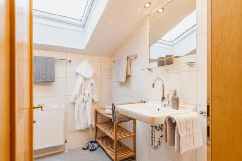 a bathroom with a sink and a skylight at Feldinggut in Bad Hofgastein