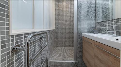 une salle de bain avec douche et lavabo dans l'établissement Midoon guest - DUPLEX D'ARCHITECT PARIS 10ème, à Paris