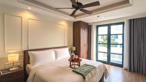 a bedroom with a large bed and a window at Anna Beach Phú Quốc in Phú Quốc