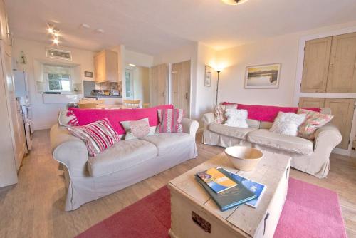 a living room with two couches and a table at Bank Top Cottage Coniston in Coniston