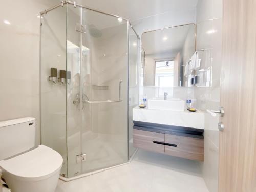 a bathroom with a shower and a toilet and a sink at Anna Beach Phú Quốc in Phú Quốc