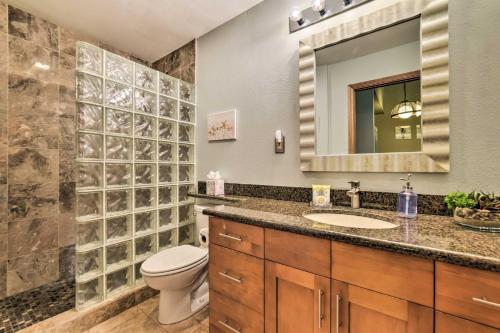 a bathroom with a toilet and a sink and a mirror at Stunning South Maui Condo with Lanai by Beach! in Kihei