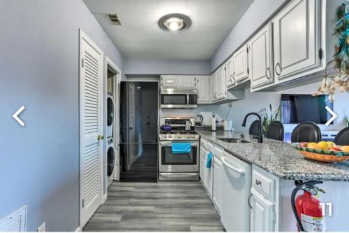 a kitchen with blue walls and white cabinets at Majesty mountains The Great spirit of Wakan Tanka in Vernon Township