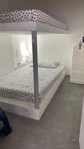 a bedroom with a bed with a polka dot canopy at Departamento de Playa en Punta Hermosa in Punta Hermosa