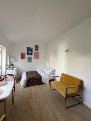 a bedroom with a bed and a couch and a chair at Brand new Tiny House w garden in Saint-Cloud