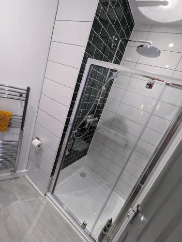 a shower with a glass door in a bathroom at Ramsgate Retreat - ultra modern 3 bed in Ramsgate