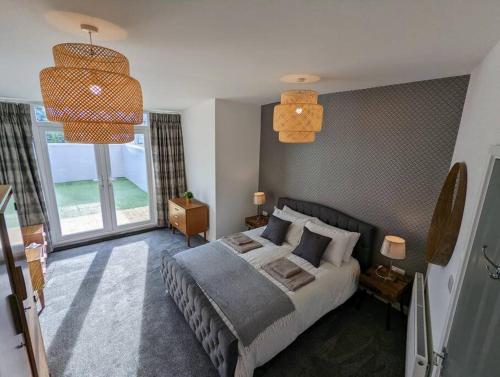 a bedroom with a bed and a large window at Ramsgate Retreat - ultra modern 3 bed in Ramsgate