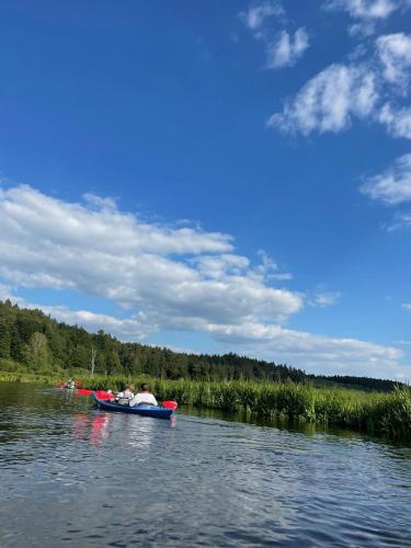 a group of people in a boat on a lake at Casa Kashubia - Nowoczesny dom wakacyjny nad jeziorem - Cisza natura i komfort in Brzeźno Szlacheckie